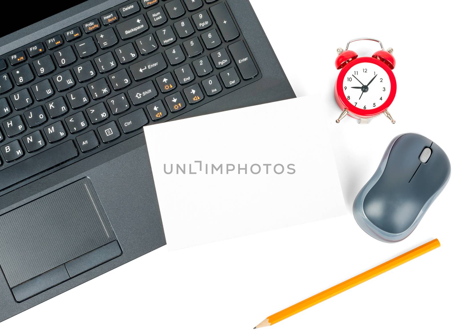 Laptop with blank card and alarm clock isolated on white background