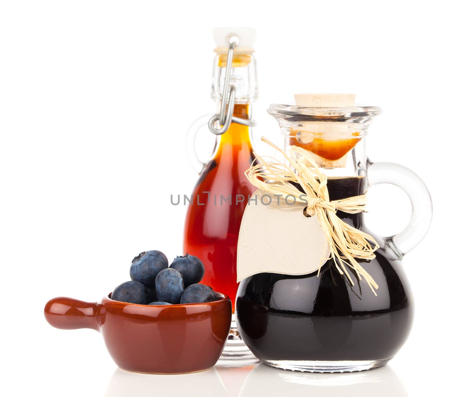 fresh blueberry and blueberry syrup in glass, bottle or mixture, on white background