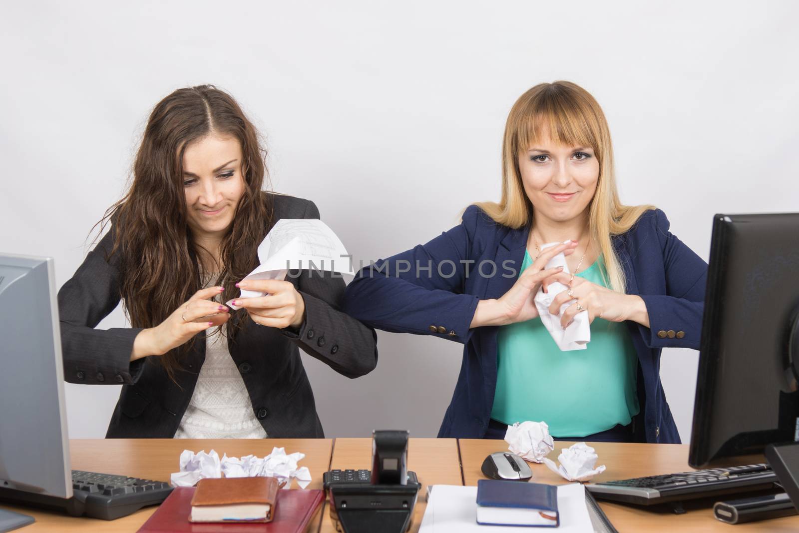 Employees of the office crumple paper with an evil expression individual