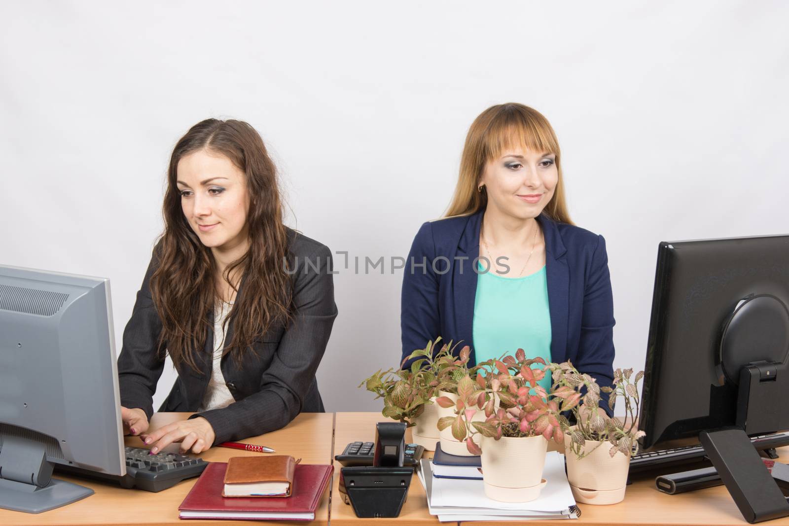 Two office employee, one of which workplace forced by plants