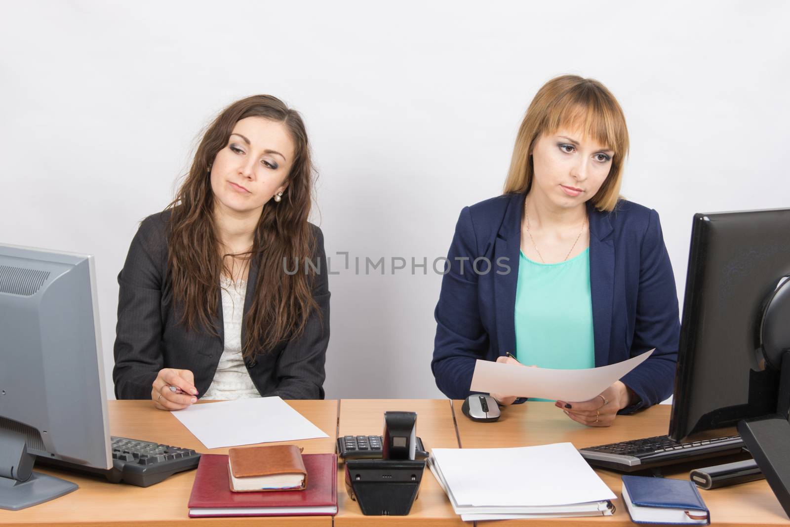 Employees of the office sitting at a desk with a view of the downtrodden