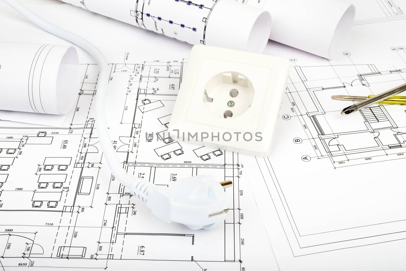 Architecture plan and rolls of blueprints with plug and socket. Building concept