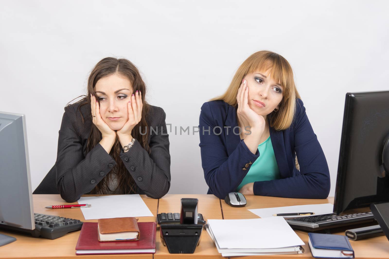  Two young office worker tired of sitting in front of computers