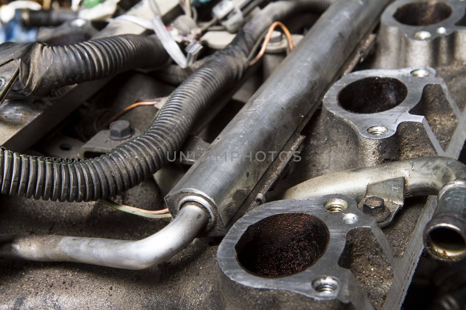Intake manifold and fuel rail on a car that is being taken apart for repair