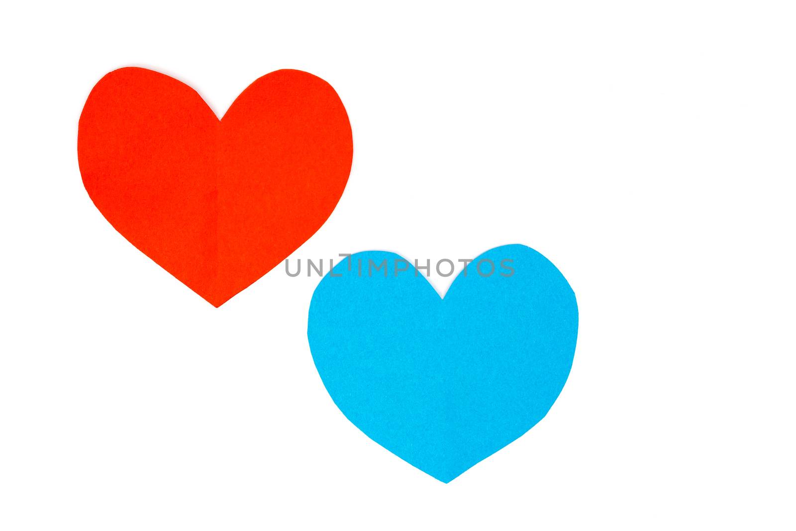 Cut red and blue paper hearts together on white background  by BenSchonewille