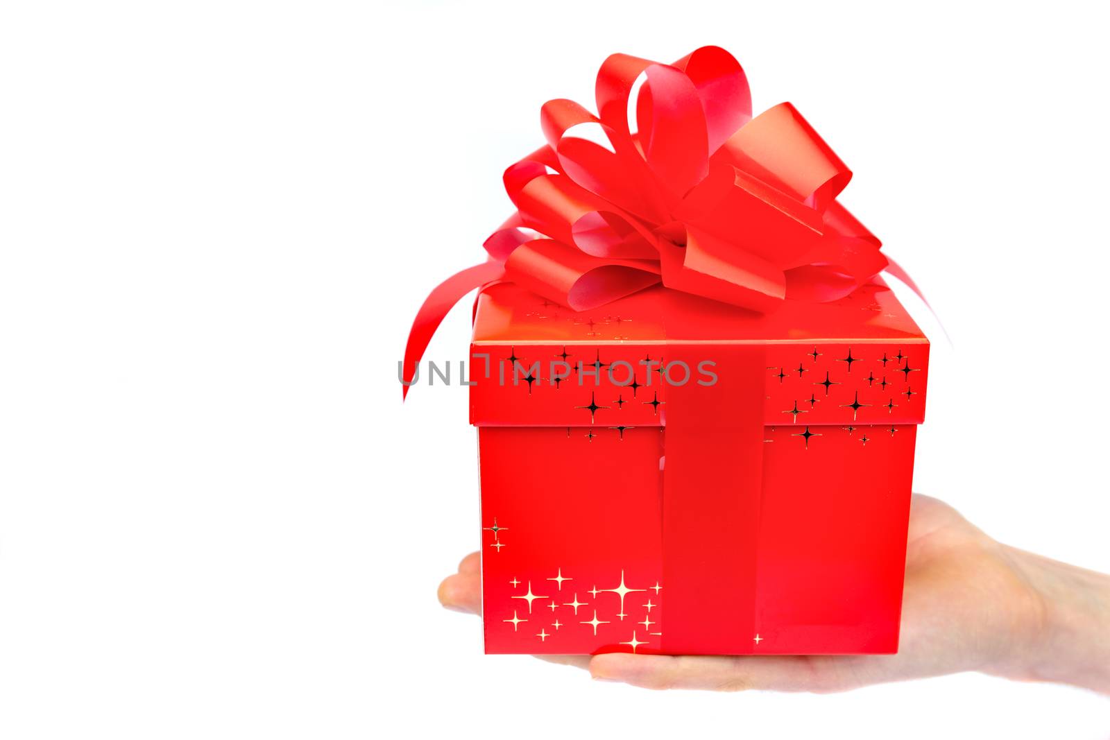 Male hand presenting red christmas box on flat hand by BenSchonewille