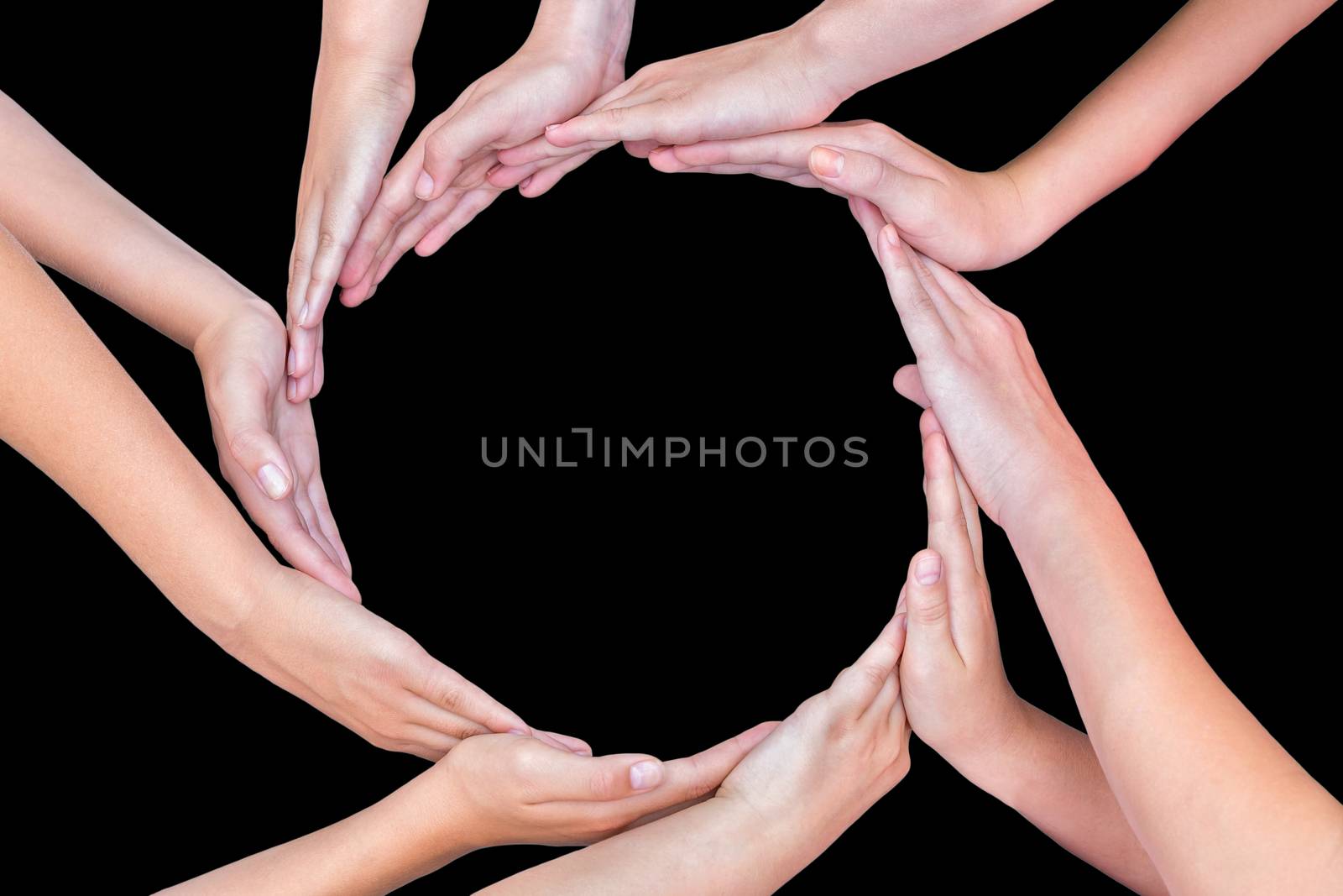 Many arms of young girls with hands making circle isolated on black background