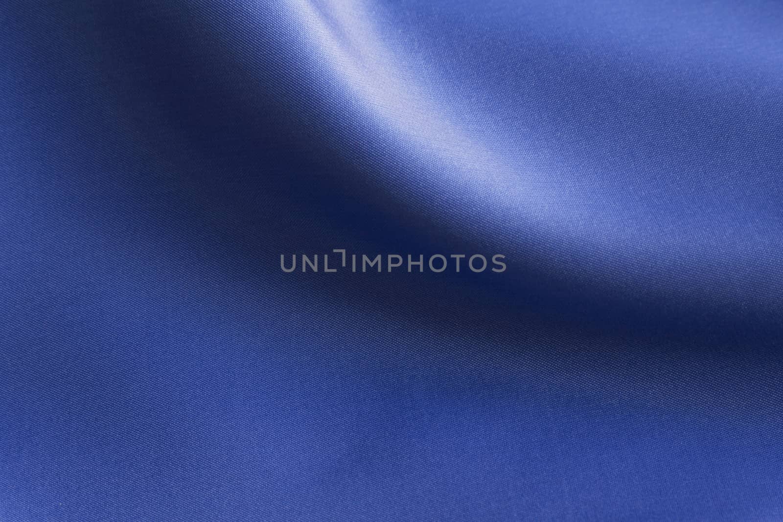 Shiny Blue silky fabric folds background texture