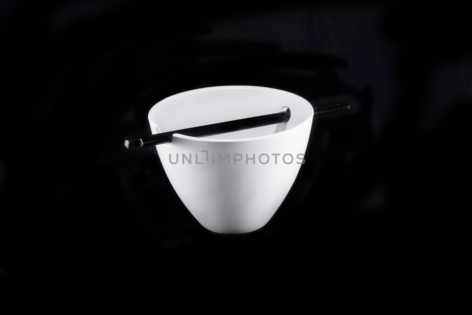 White bowl with chopsticks