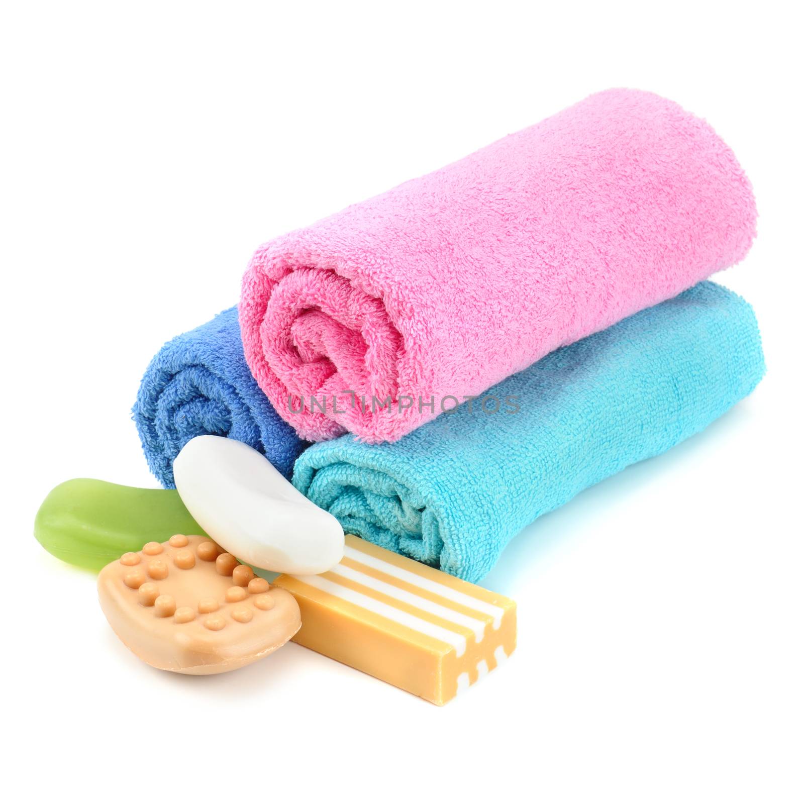 Stack of towels and soap isolated on white background