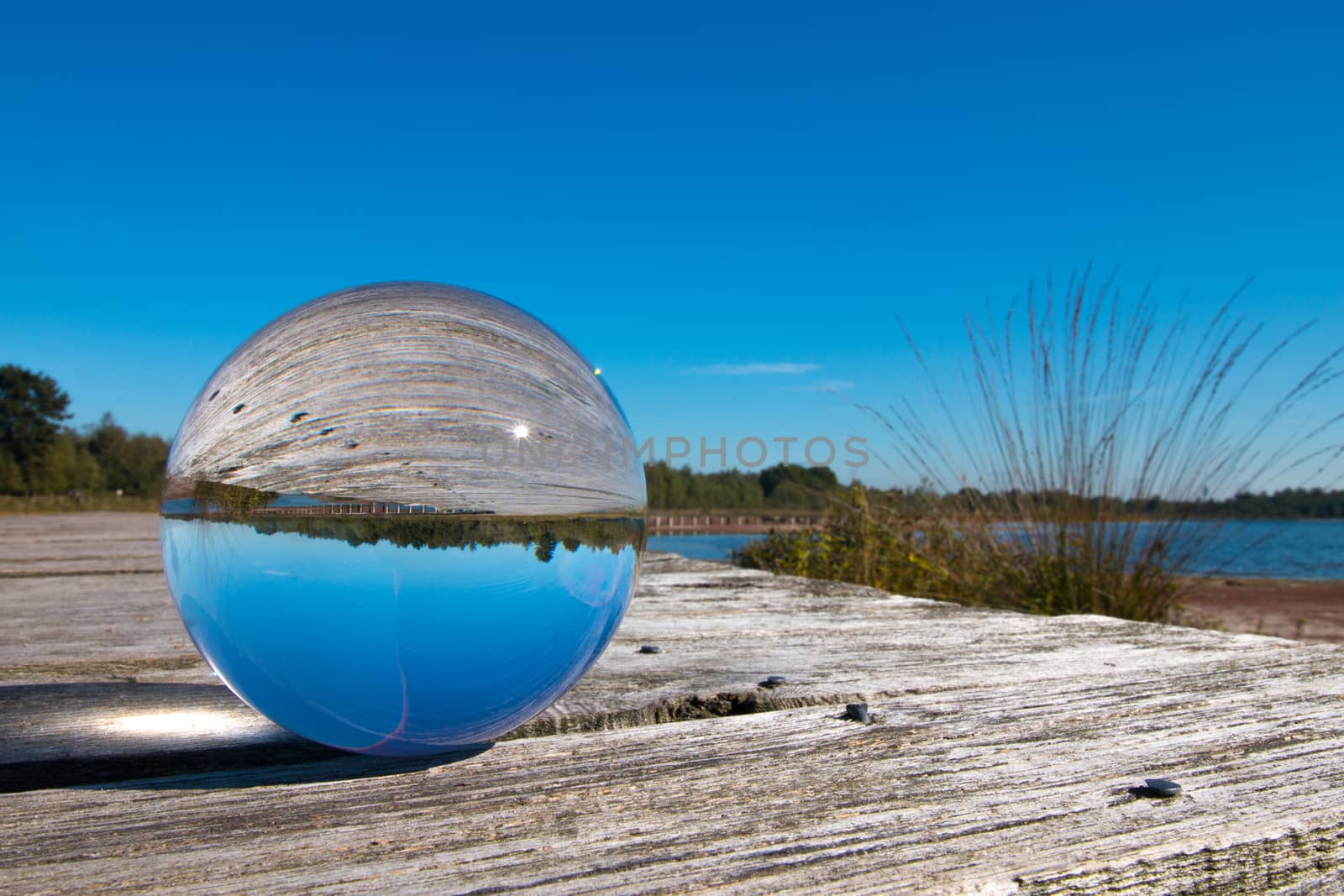 Landscape with blue sky in glass sphere