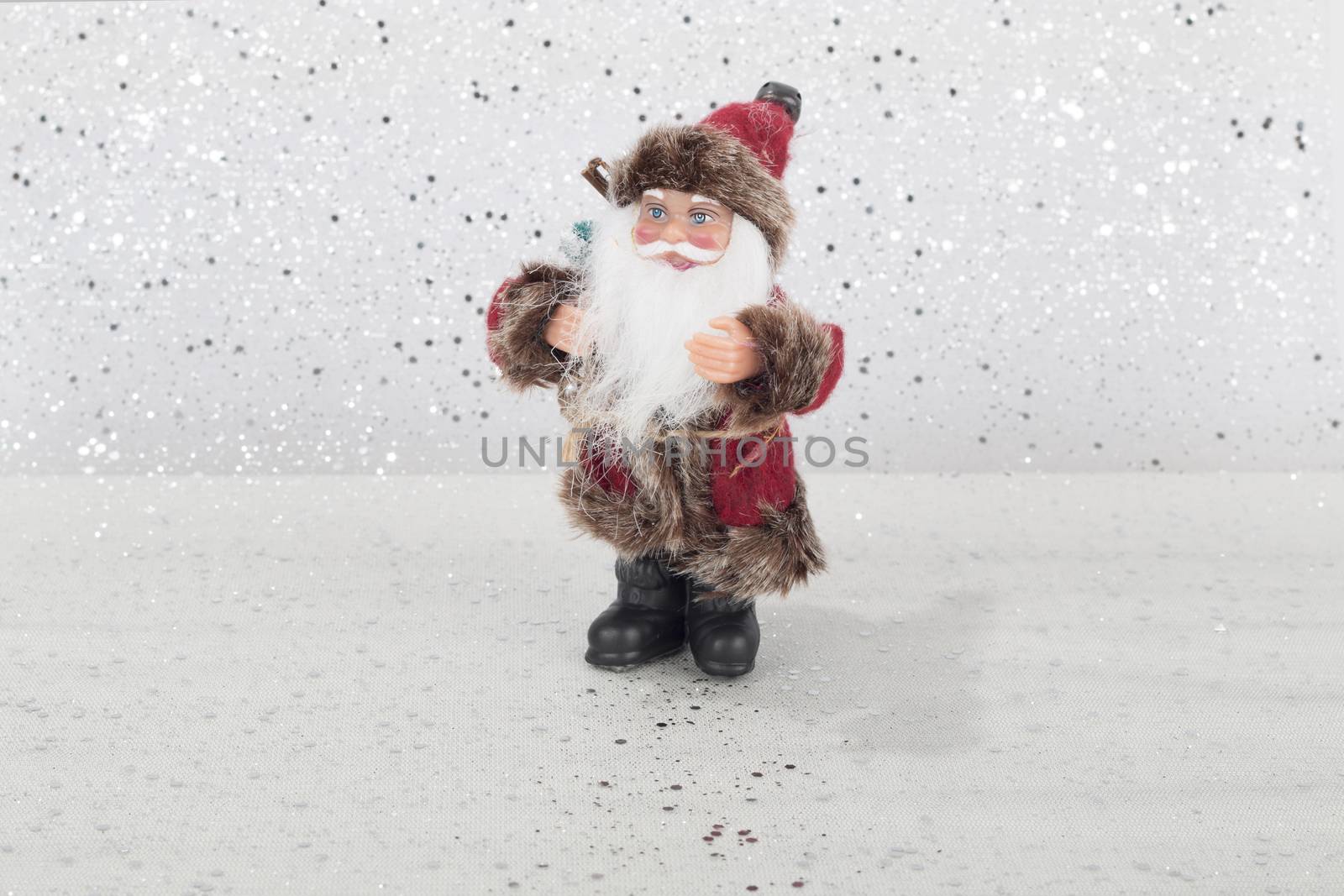 Santa Claus doll on silver and white background