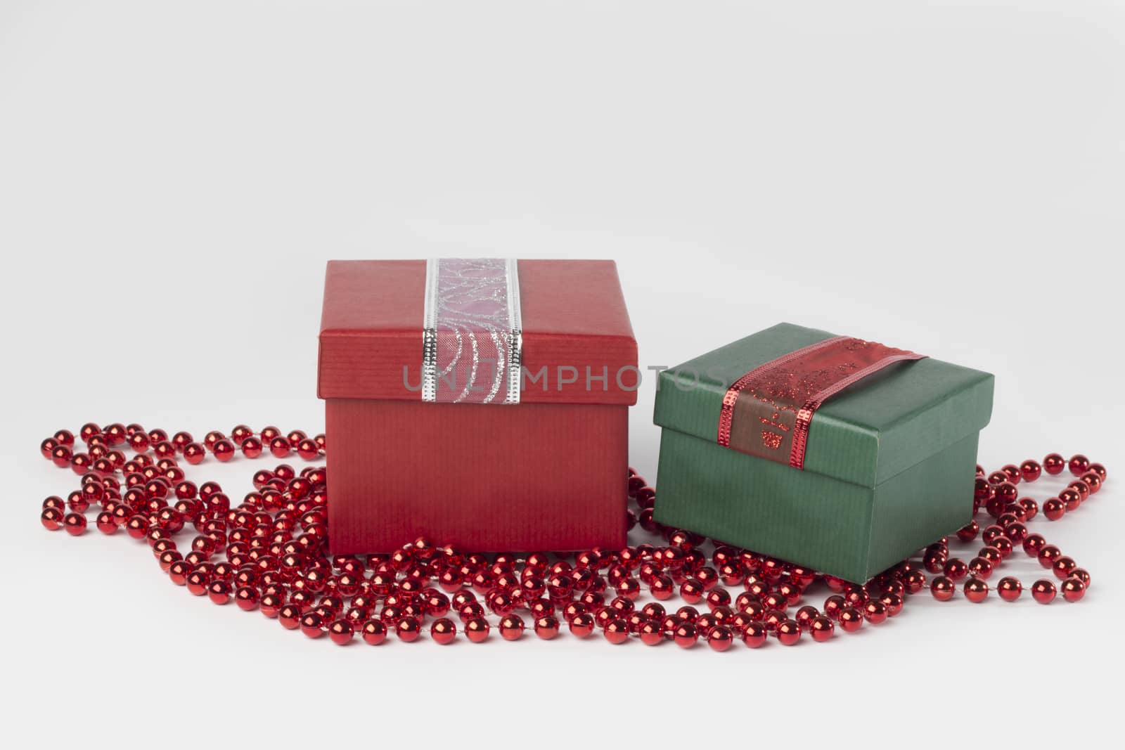 Two presents, red and green, with ribbons, isolated on white background
