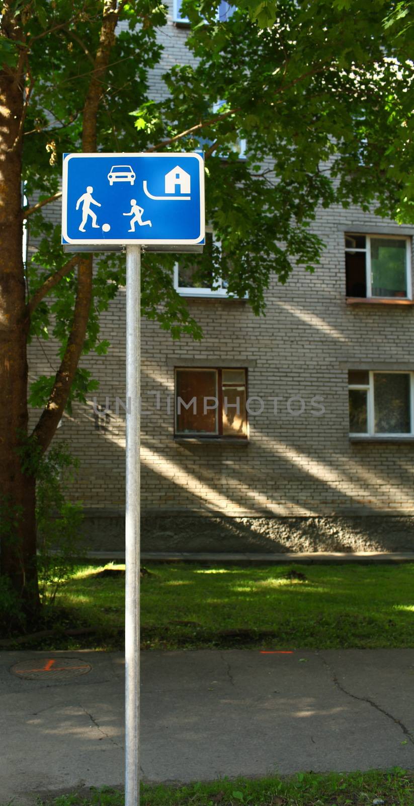 road sign children playing with a ball