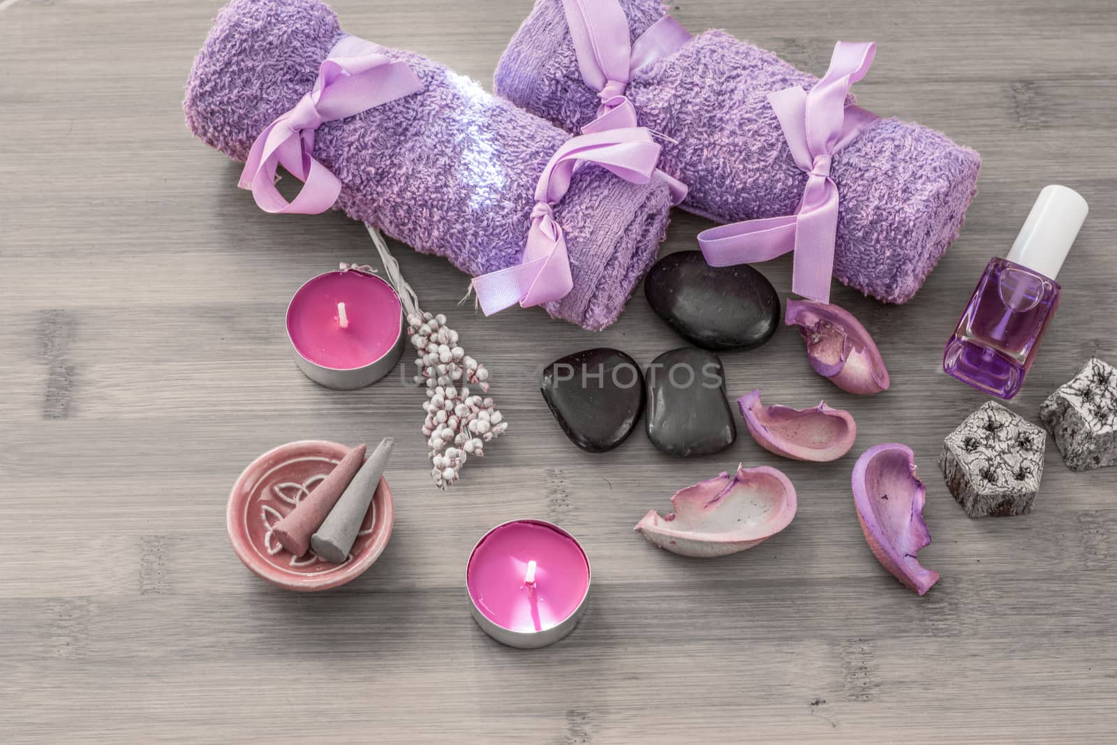 Spa concept. Lavender oil, lavender flowers and bath white and purple towels