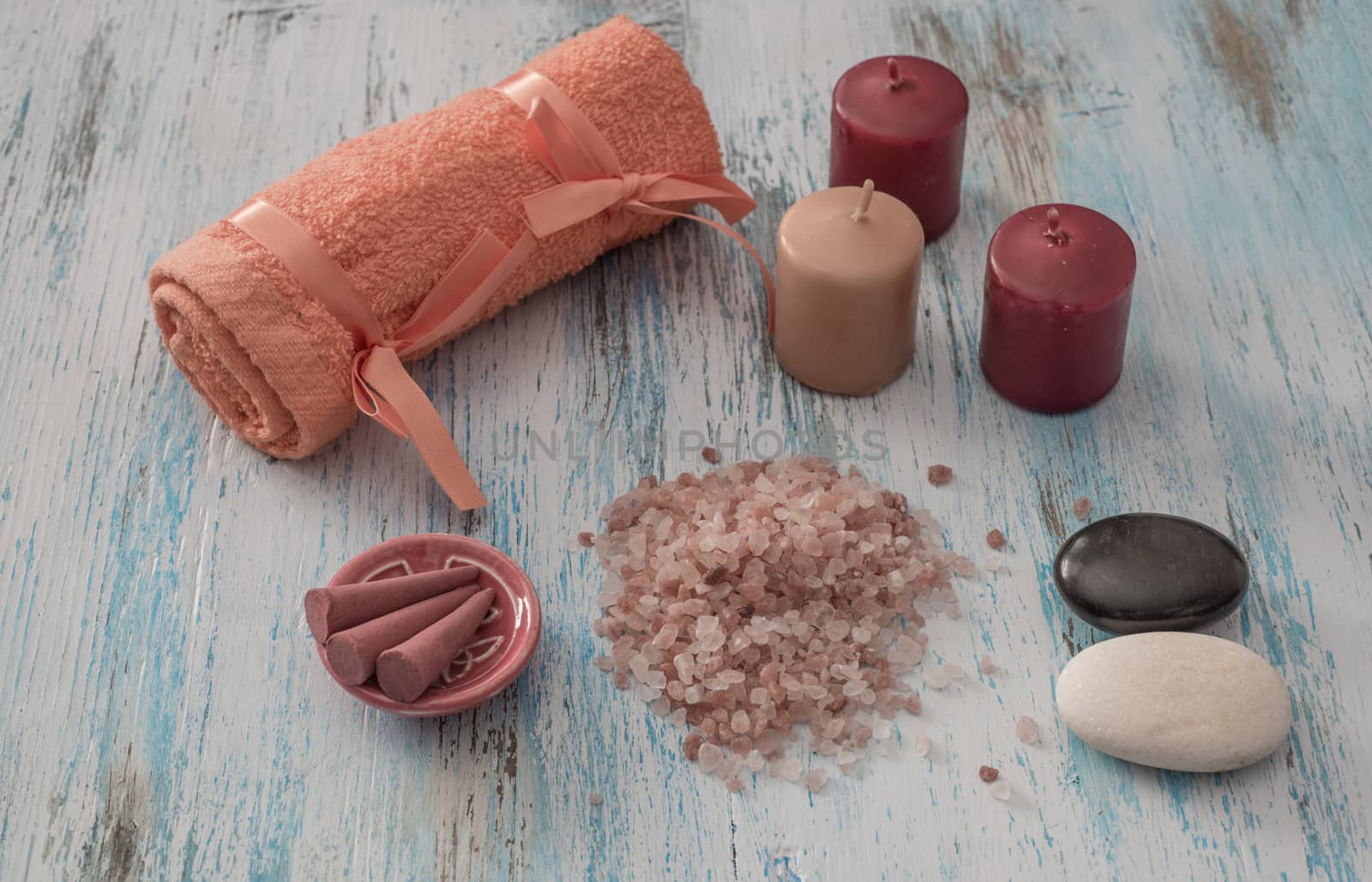 Spa concept. candles, aromatic salt, and bath orange towel  on wooden background