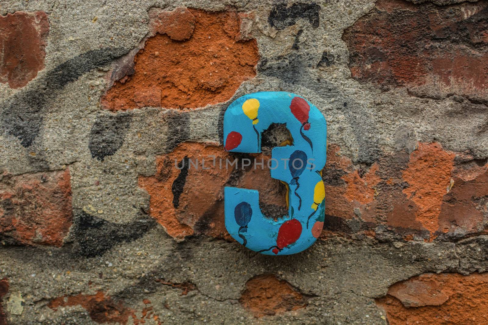 Funny number three on a house wall