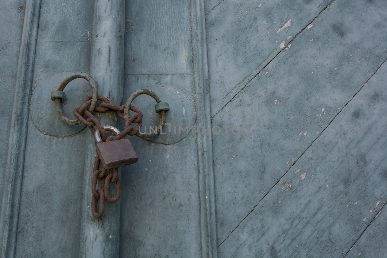 Old padlock on a blue wooden door
