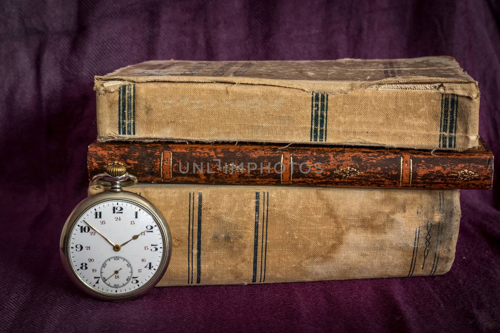Vintage  still life with pocket watch, and old book