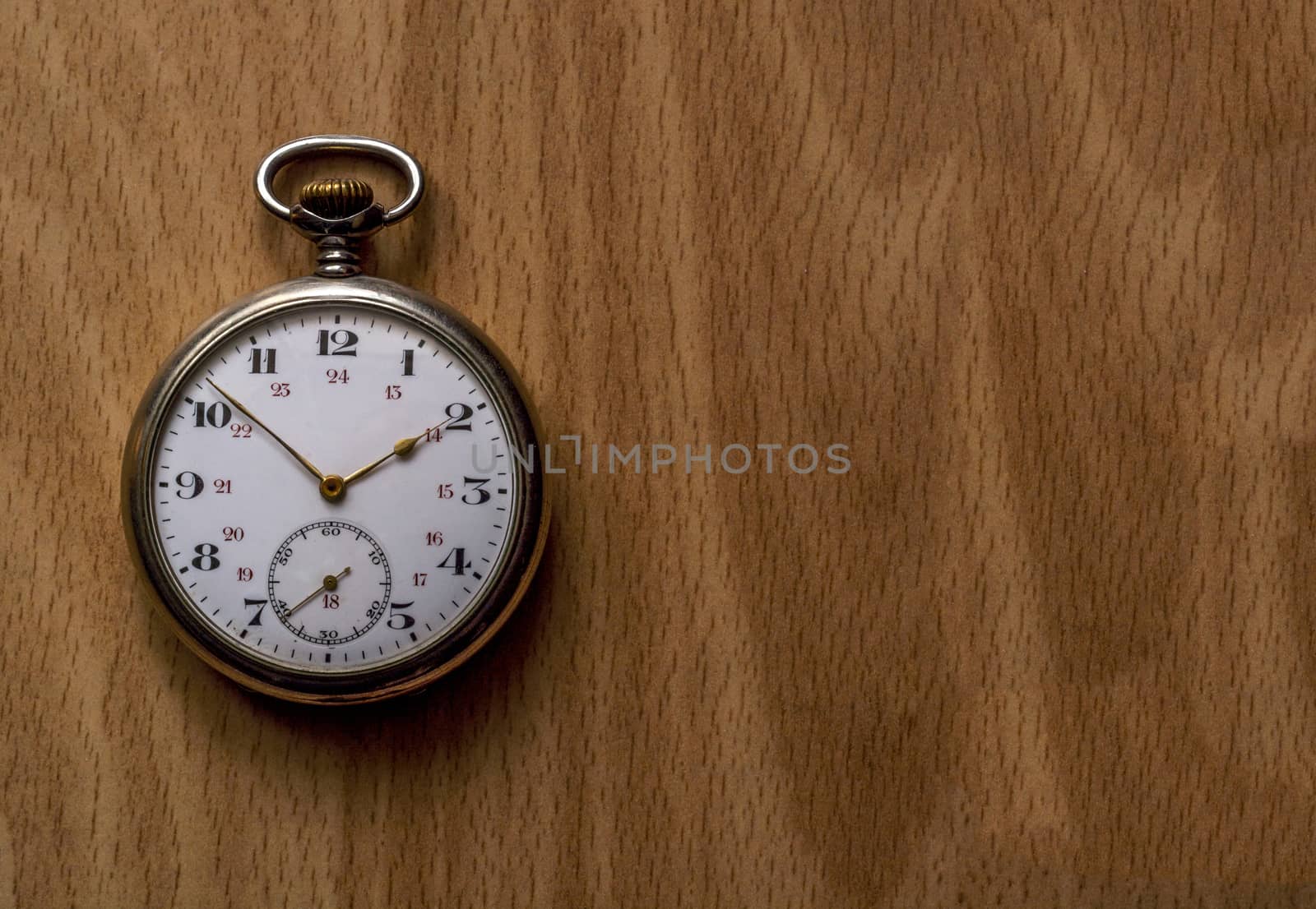 Vintage pocket watch on wooden surface