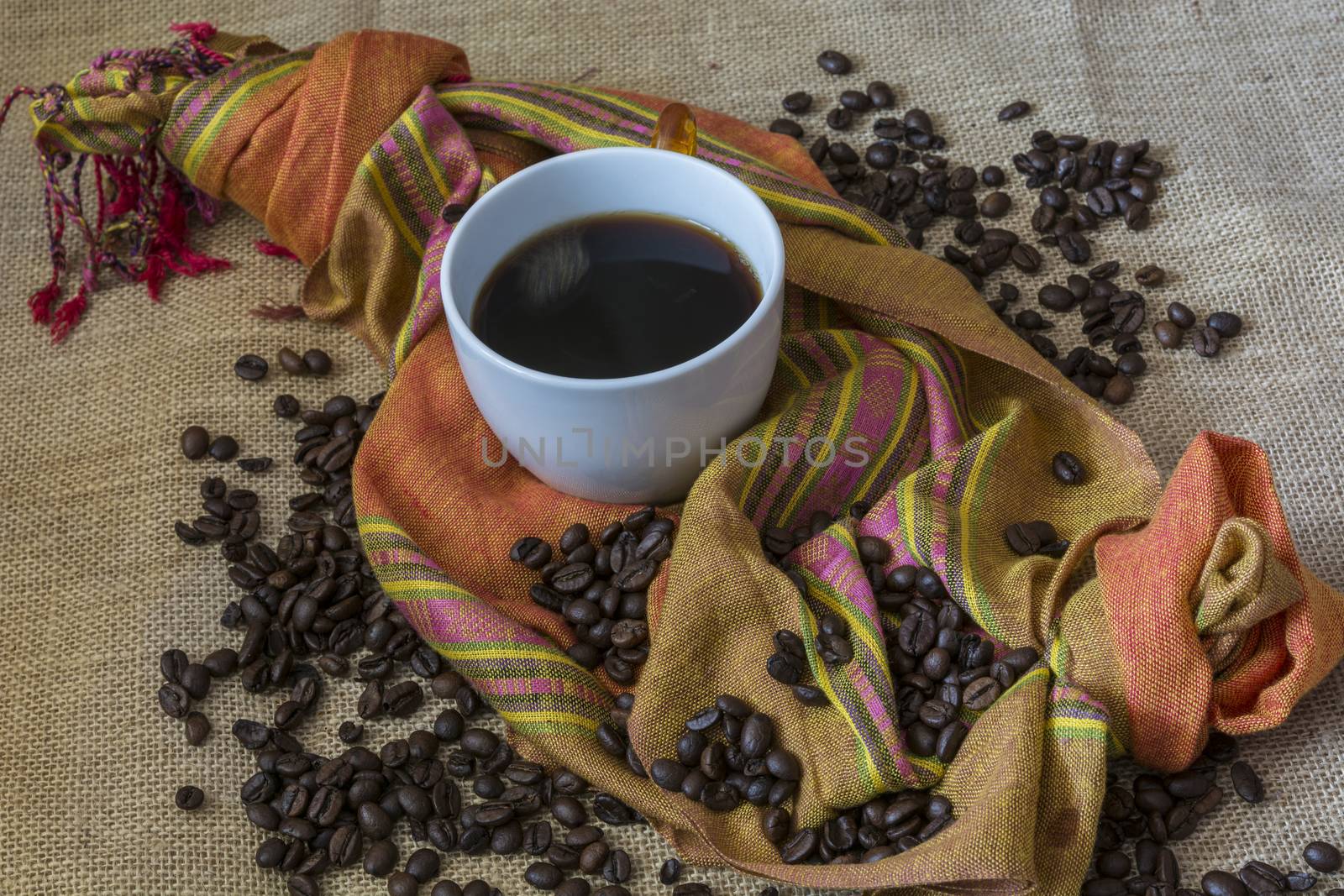 A Cup of coffee with cinnamon and coffee beans