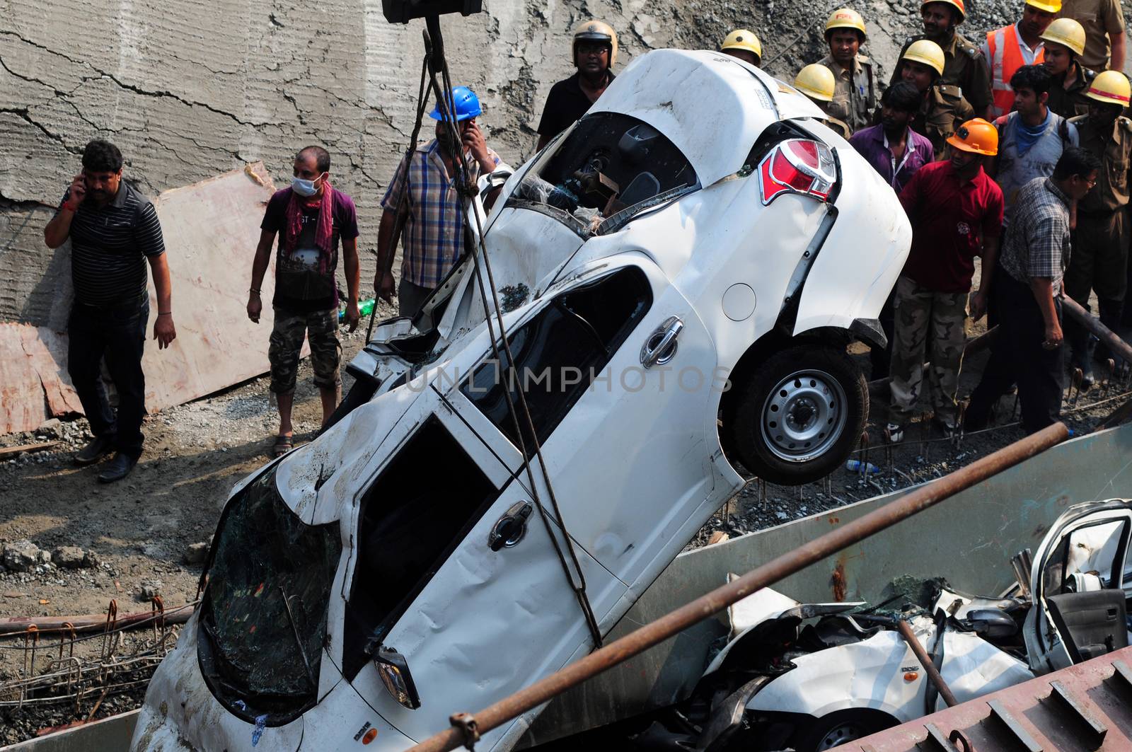INDIA, Kolkata: Indian rescue workers and volunteers try to free people trapped under the wreckage of a collapsed flyover bridge in Kolkata on March 31, 2016. At least 14 people were killed and dozens more injured when a flyover collapsed in a busy Indian city on March 31, an official said, as emergency workers battled to rescue people trapped under the rubble.
