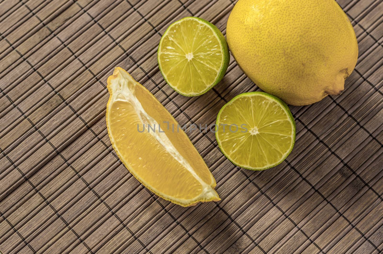 Lemon and limes,sliced on a woodenboard