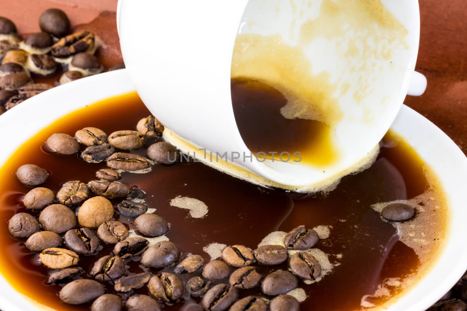 Spilled coffee with liquid and bean