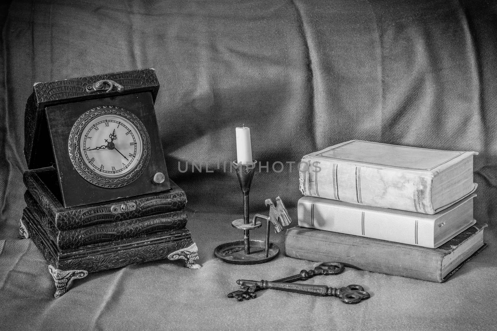 Vinatge still lifewith clock,books,candle and keys in black and white
