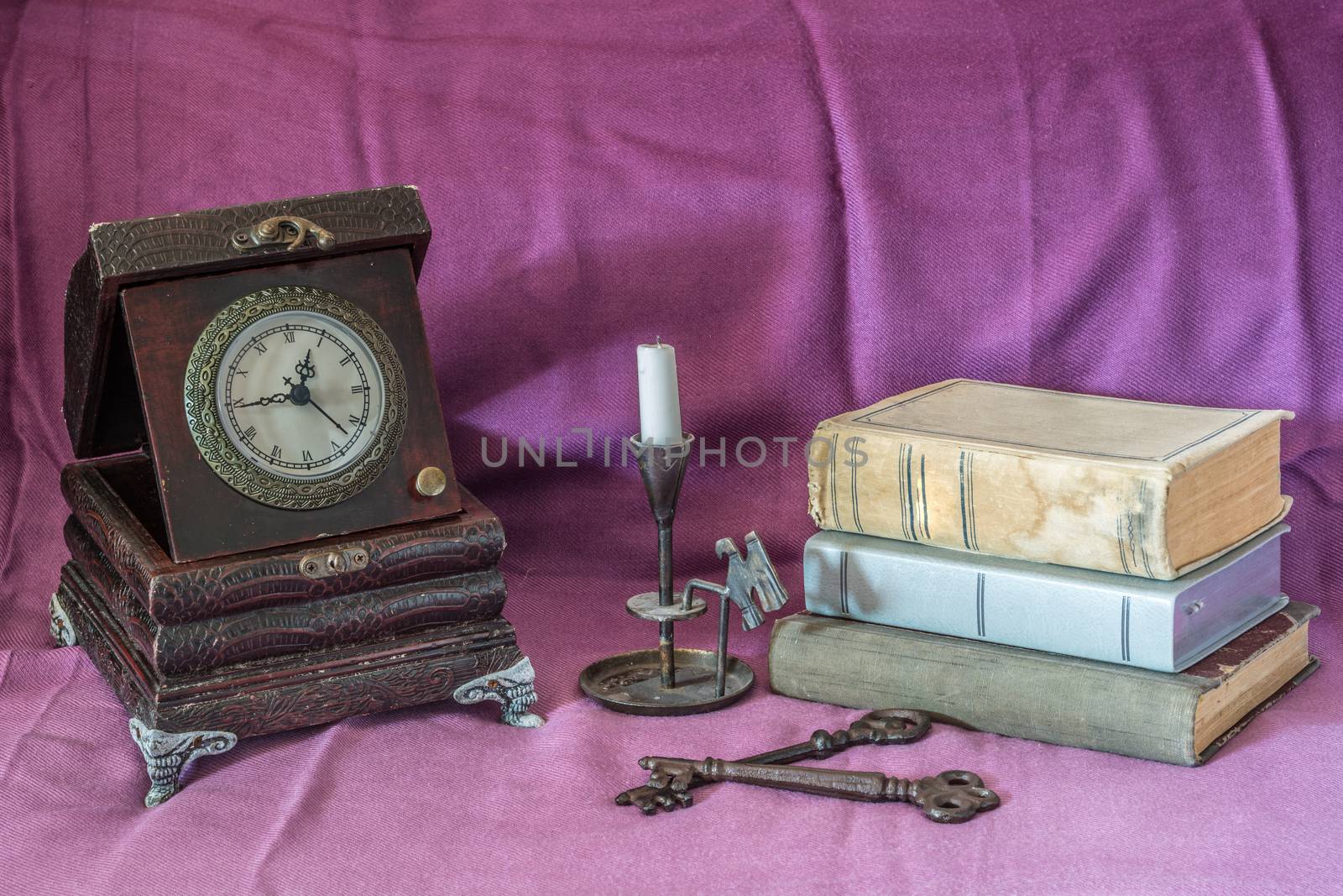 Retro still life with clock,books and candle