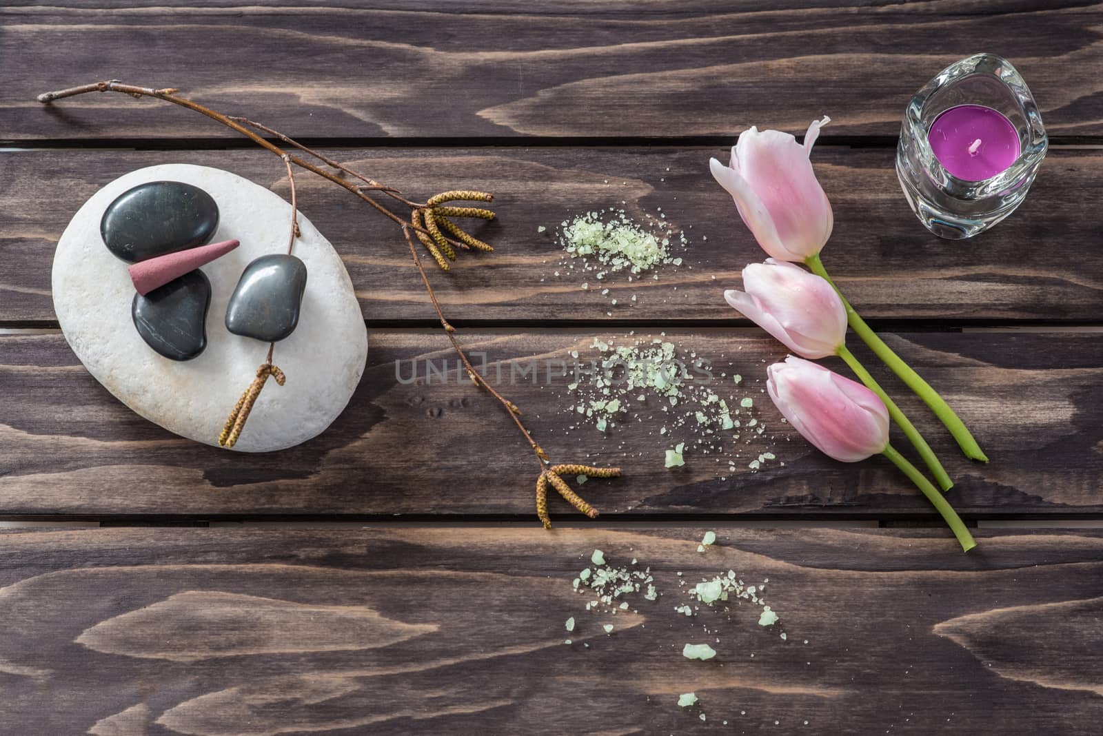 Spa concept. flowers,candles, aromatic salt on wooden background