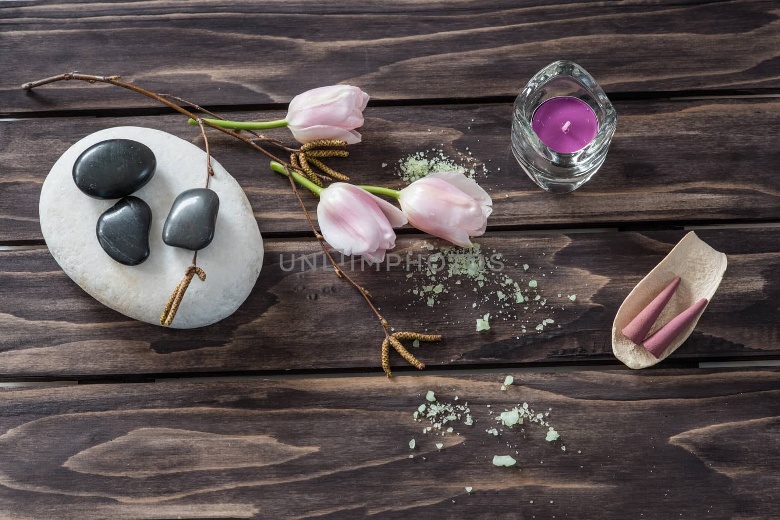 Spa concept. flowers,candles, aromatic salt on wooden background