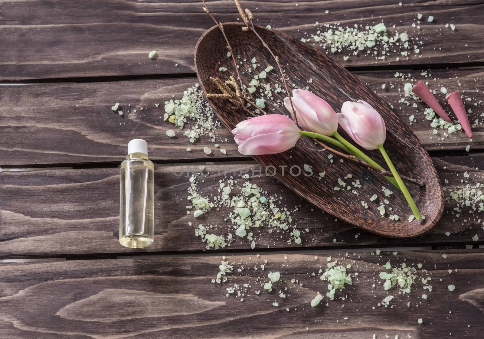 Spa concept. flowers,lavender oil, aromatic salt,on wooden background