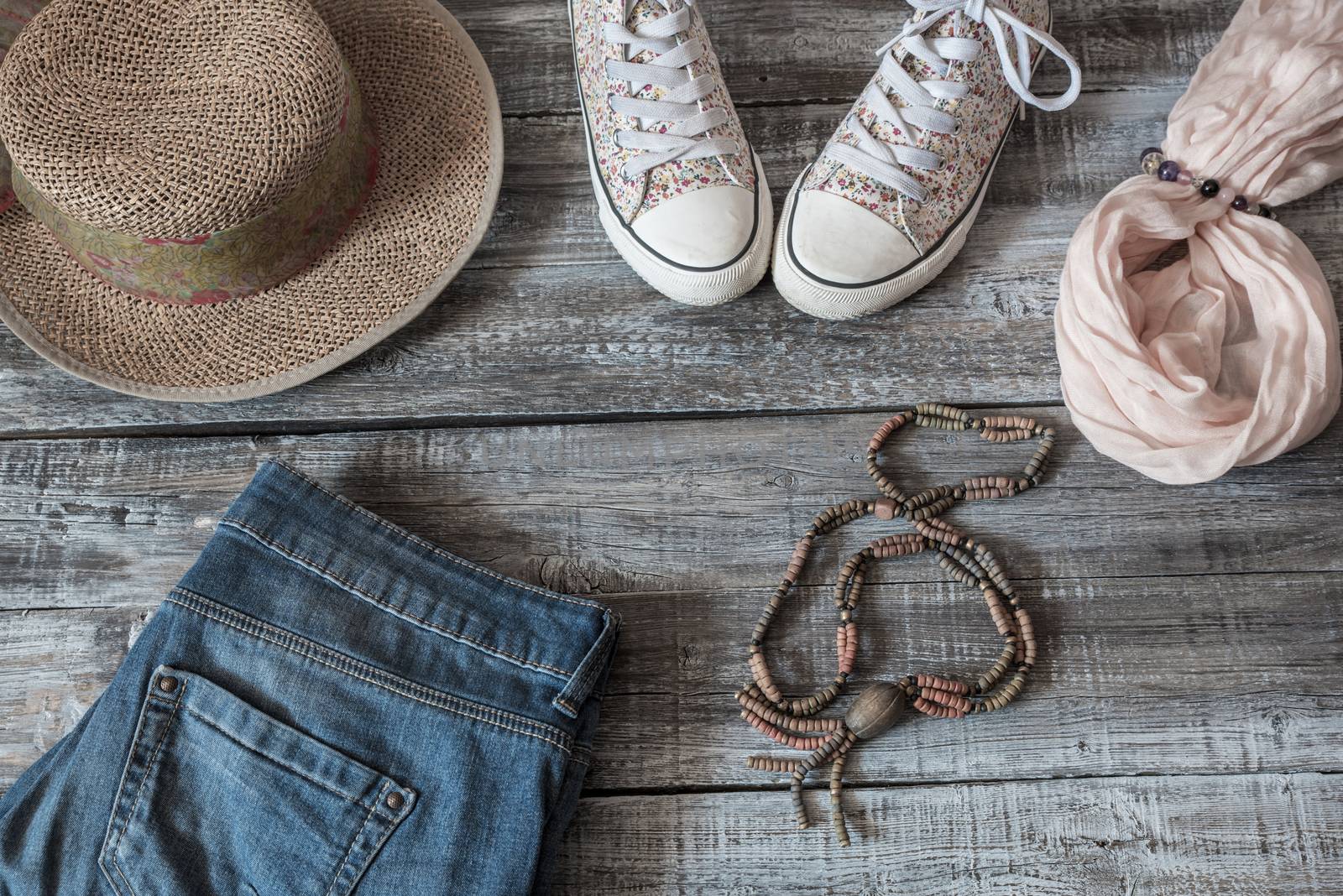 Vintage still life of random objects of modern woman on wooden board