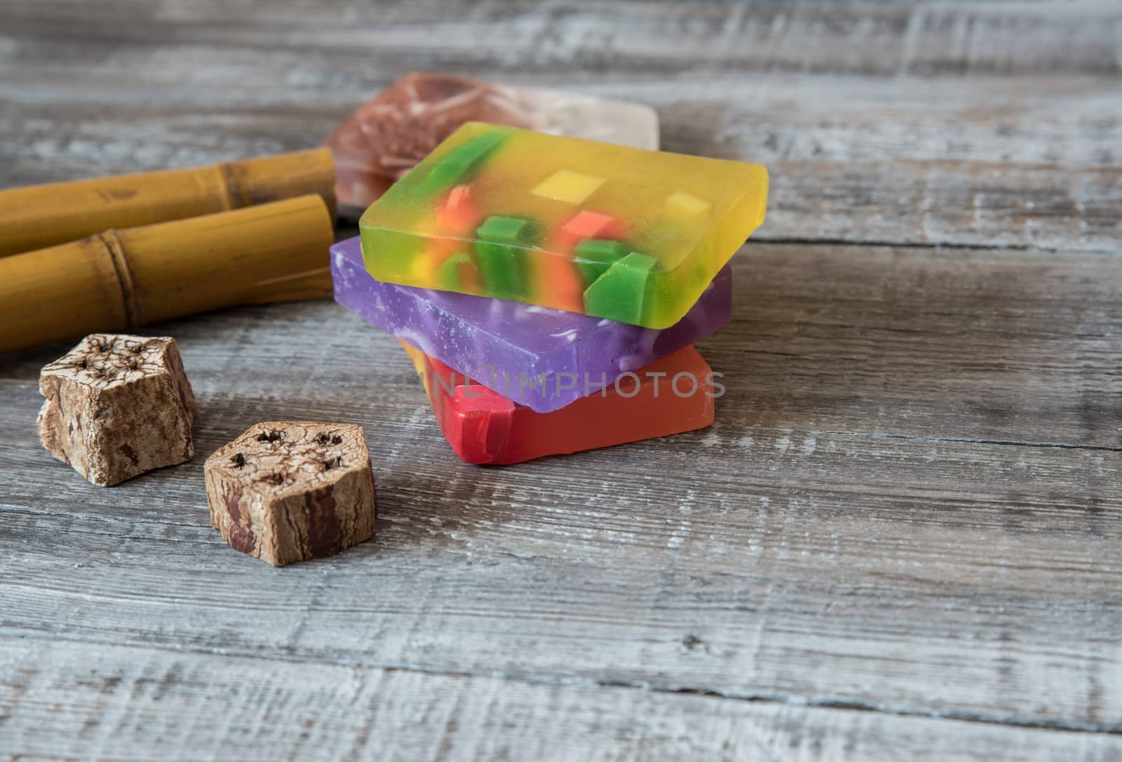 Spa concept. aromatic soaps and bamboo sticks on wooden background