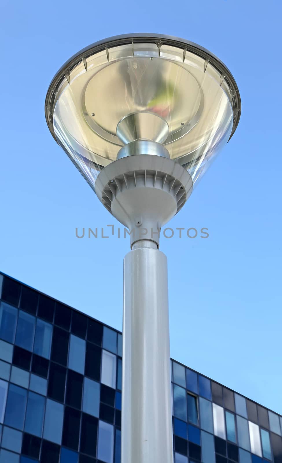 modern street lamp on background of blue sky and modern buildings