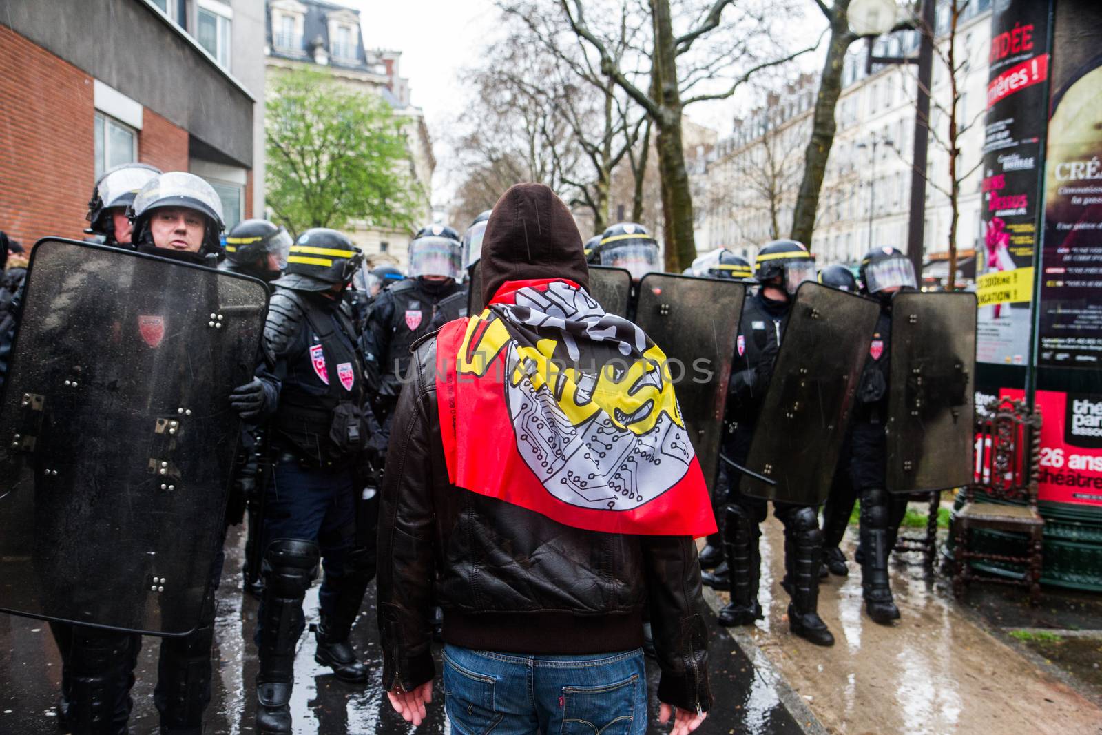 FRANCE, Paris: A protester faces police officers as thousands march against the French government's planned labor law reforms on March 31, 2016 in Paris. France faced fresh protests over labour reforms just a day after the beleaguered government of Presid