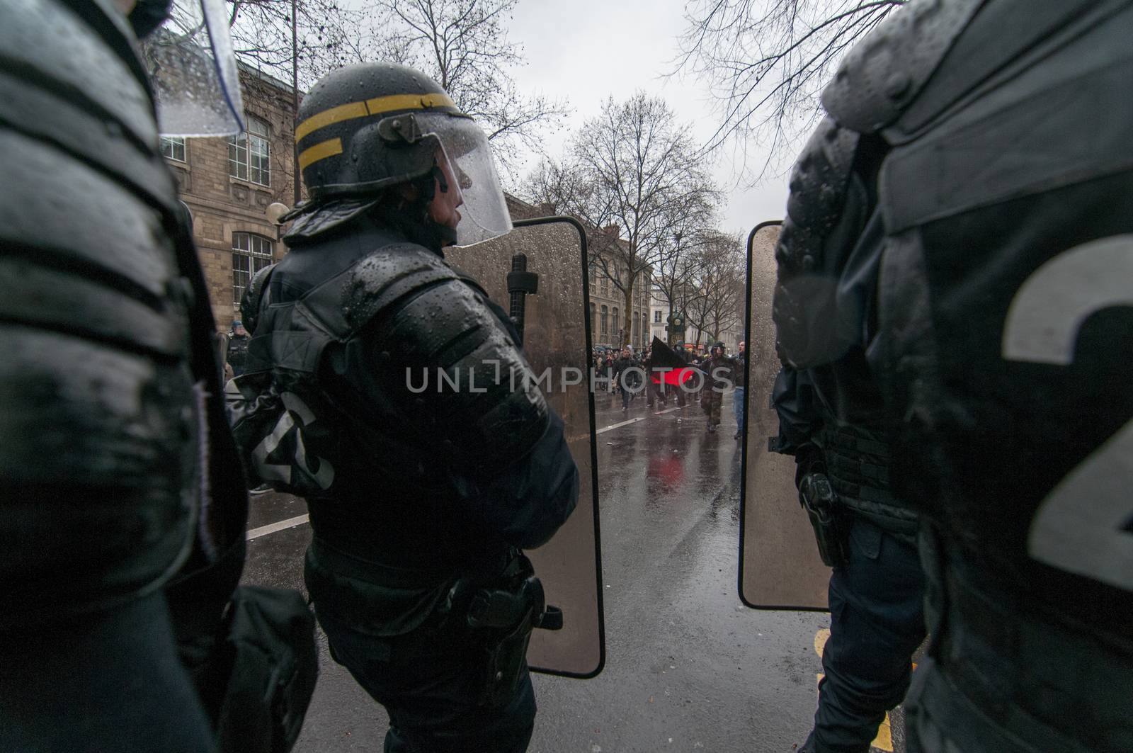 FRANCE, Marseille: Police satnd front facing protesters during a demonstration against the French government's planned labour law reforms on March 31, 2016 in Paris. France faced fresh protests over labour reforms just a day after the beleaguered government of President Francois Hollande was forced into an embarrassing U-turn over constitutional changes.