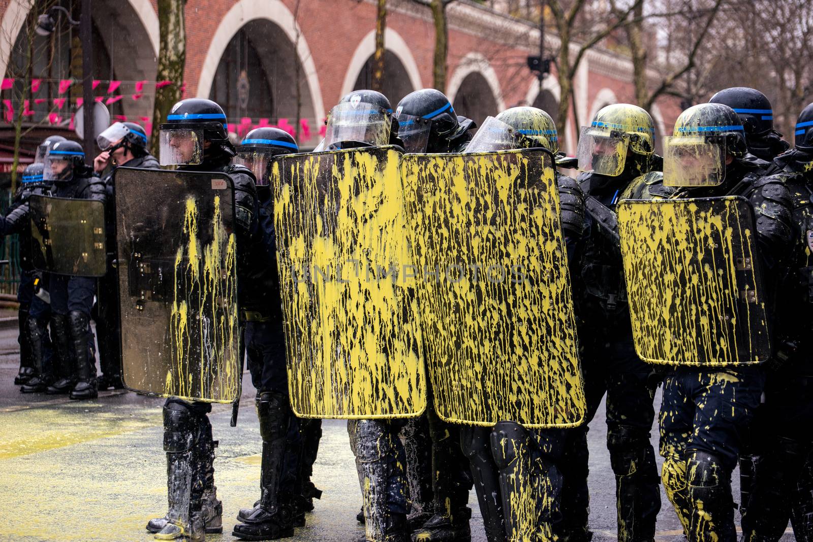 FRANCE, Paris: French riot police officers with yellow paint on their shields stand in line as thousands demonstrate against the French government's planned labour law reforms on March 31, 2016 in Paris. France faced fresh protests over labour reforms just a day after the beleaguered government of President Francois Hollande was forced into an embarrassing U-turn over constitutional changes.