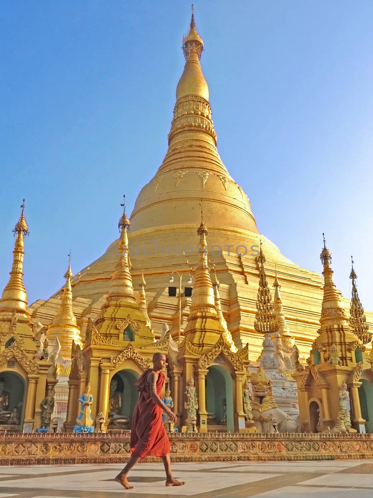  Buddhist monk walking in Shwedagon pagoda, the famous atrraction in Myanmar.
