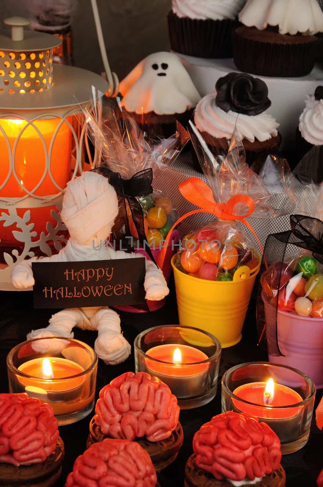 Cookies  marzipan on a table with a variety of sweets in honor of Halloween
