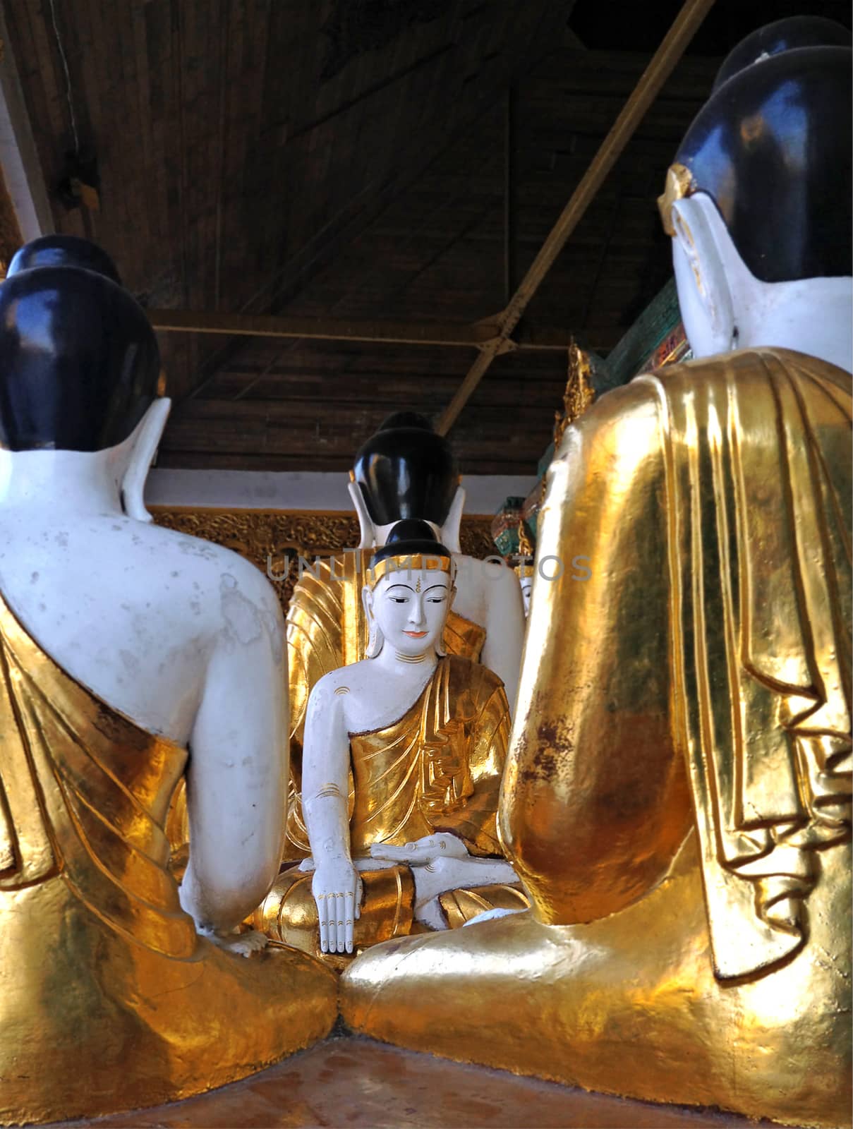 Gold and white Buddha statues at the Shwedagon Pagoda in Yangon, Myanmar