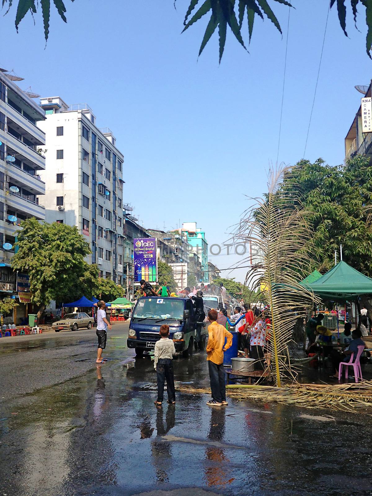 YANGON, MYANMAR - APRIL 16, 2013 :Day traffic moves easily past the water platforms during the Thingyan Water Festival in Yangon, Myanmar