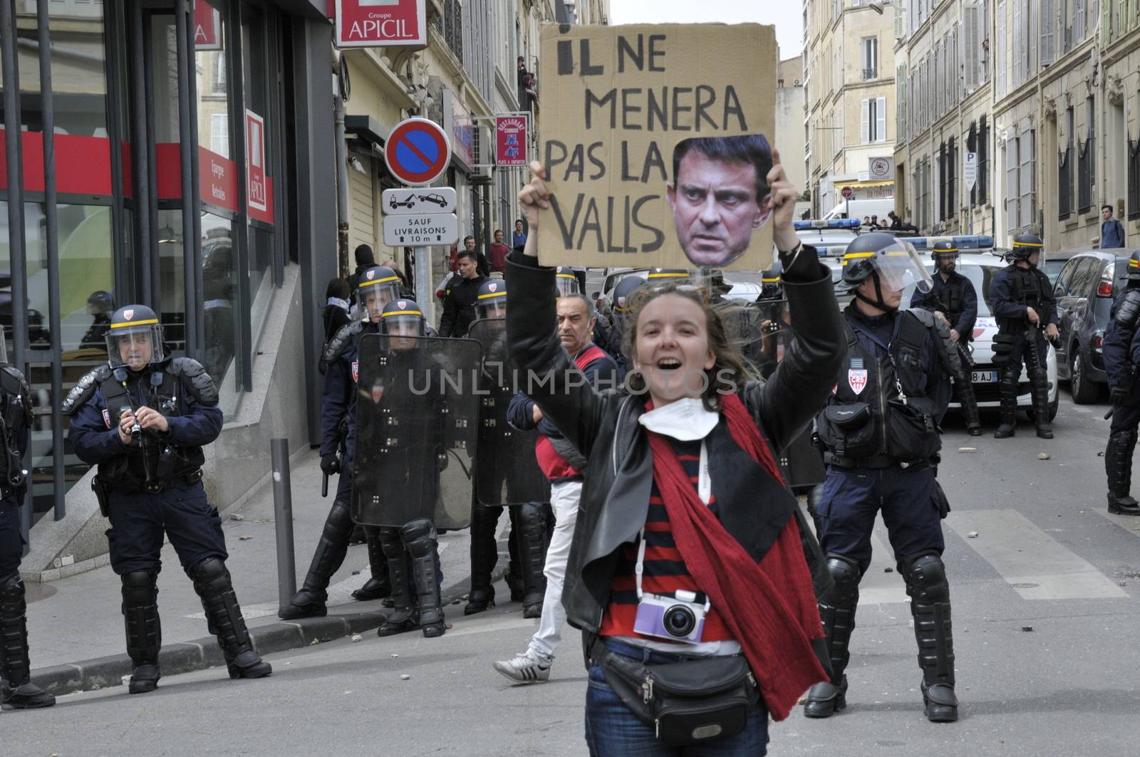 FRANCE, Marseille: A protester holds a sign reading 'He will not lead the Valls' (homonym for waltz in French) as thousands of protesters march during a demonstration against the French government's planned labour law reforms on March 31, 2016 in Marseille. France faced fresh protests over labour reforms just a day after the beleaguered government of President Francois Hollande was forced into an embarrassing U-turn over constitutional changes.