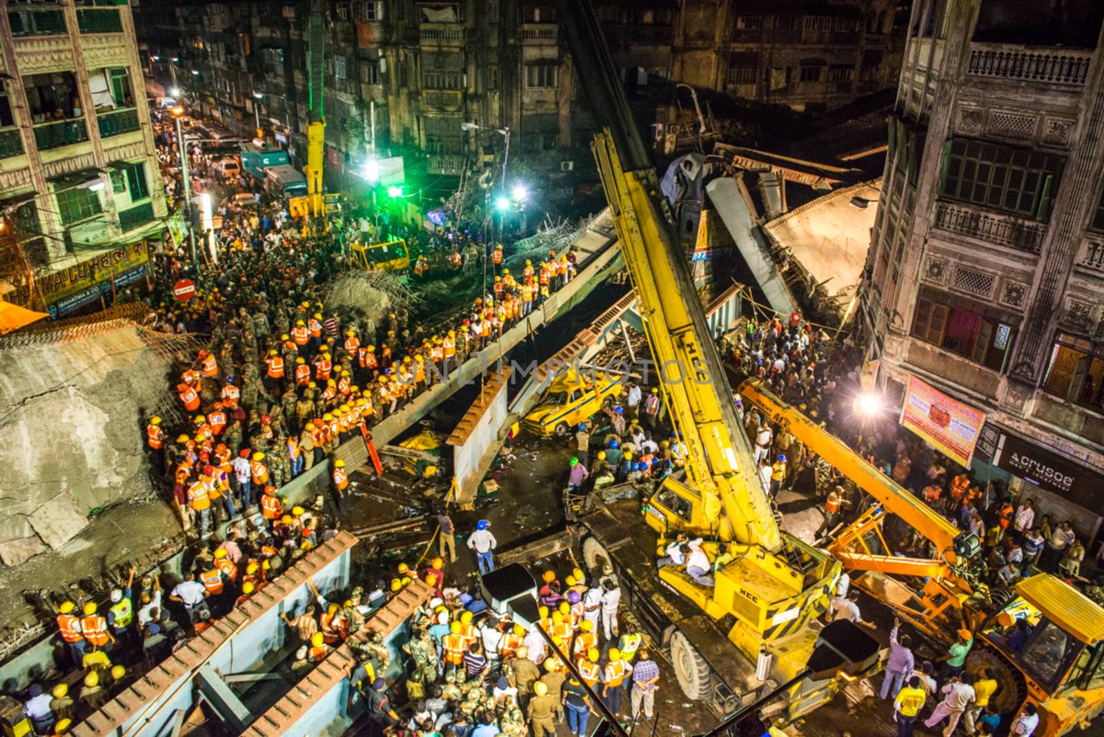 INDIA, Kolkata: Rescue workers and volunteers search for survivors of a bridge collapse that left at least 15 dead and dozens more injured in Kolkata, India on March 31, 2016.