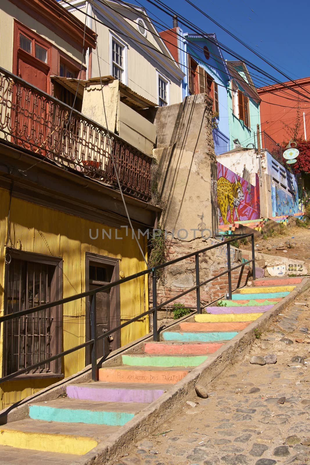 Colourfully decorated houses and steps on Templeman, a historic street in the UNESCO World Heritage port city of Valparaiso, Chile.