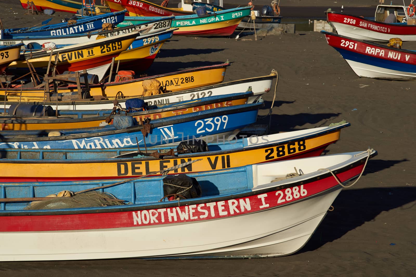 Colourful fishing boats on the beach in the small fishing village of Curanipe in the Maule Region of Chile.