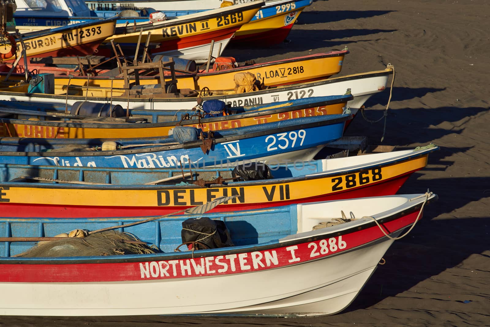 Colourful fishing boats on the beach in the small fishing village of Curanipe in the Maule Region of Chile.