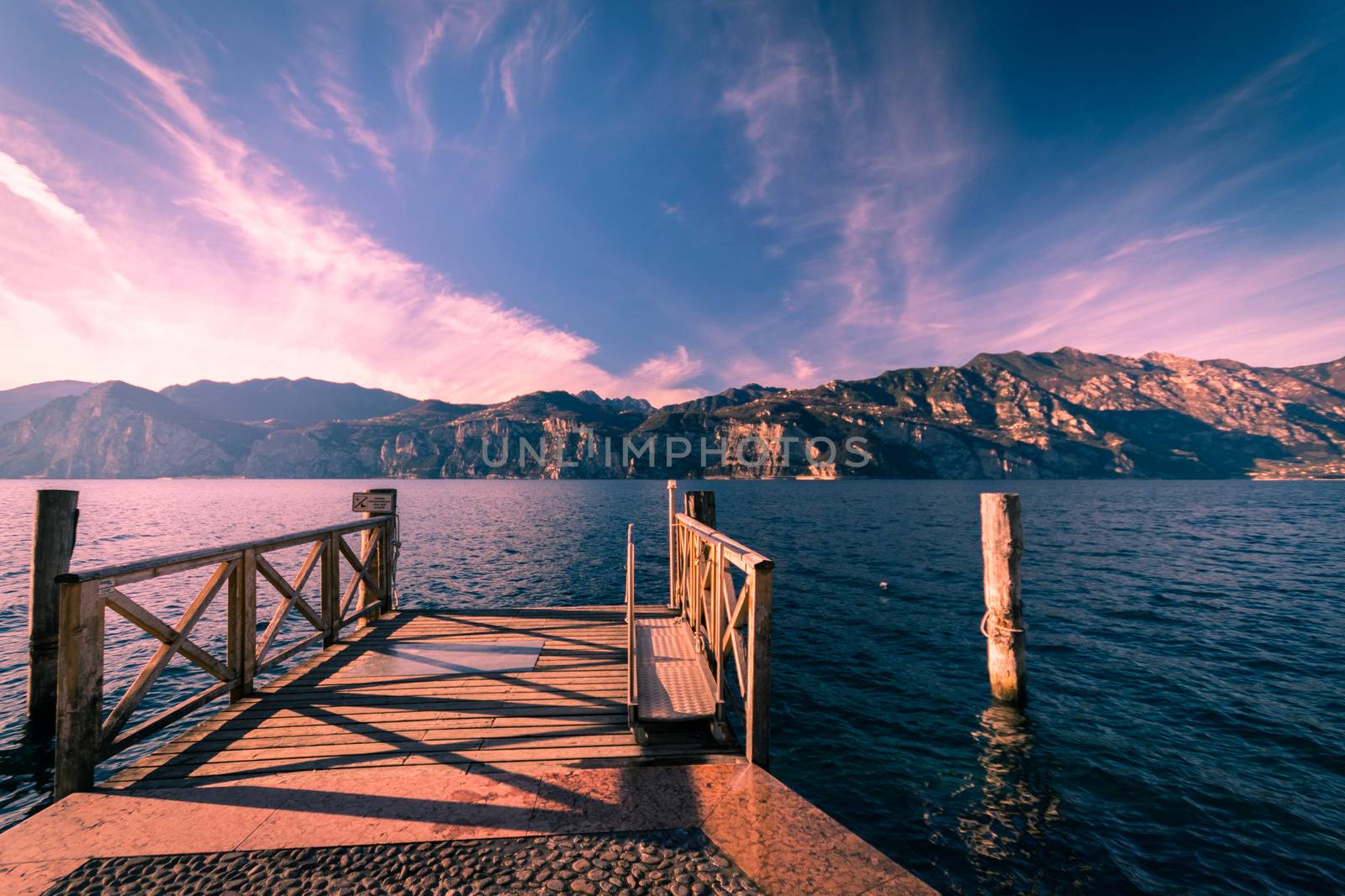 Walkway over the Lake Garda near Malcesine at sunset.