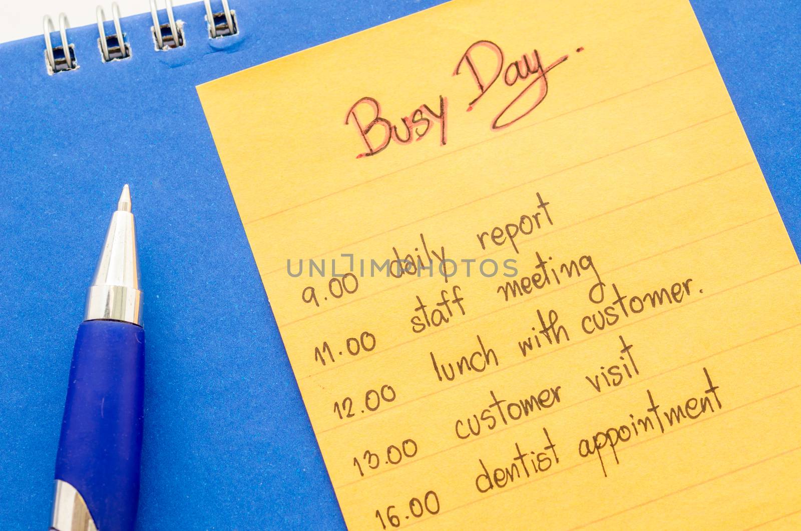 business hand writing appointment schedule on paper note.
